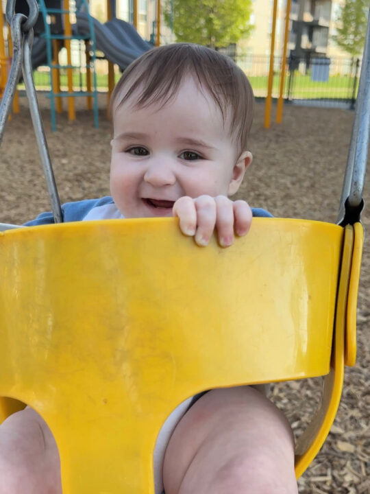 Jack enjoying a swing at the park