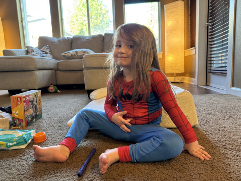 Olivia smiling in Spidey jammies