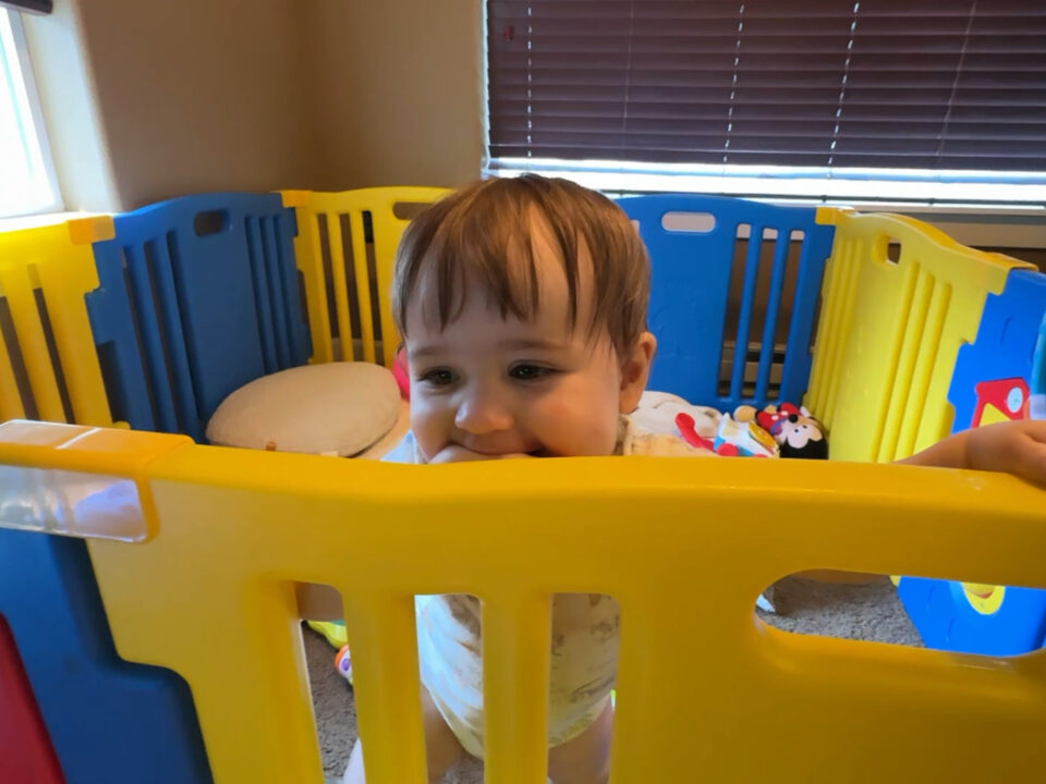 Jack smiling while in his playpen