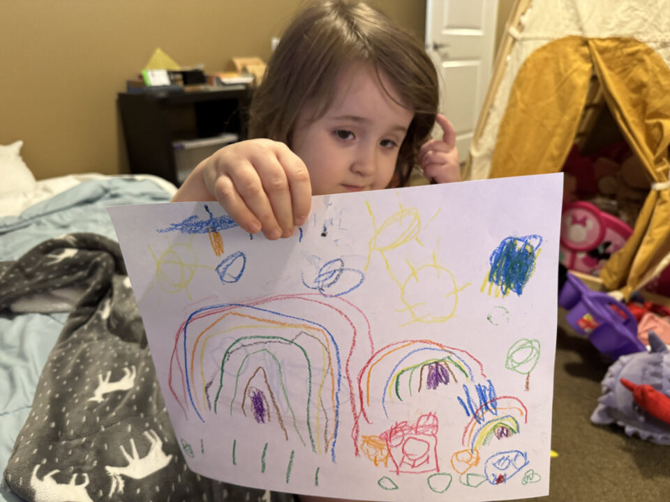 Olivia showing off her artwork
