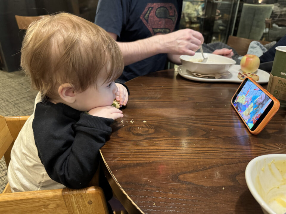 Jack seated at a table with a smartphone