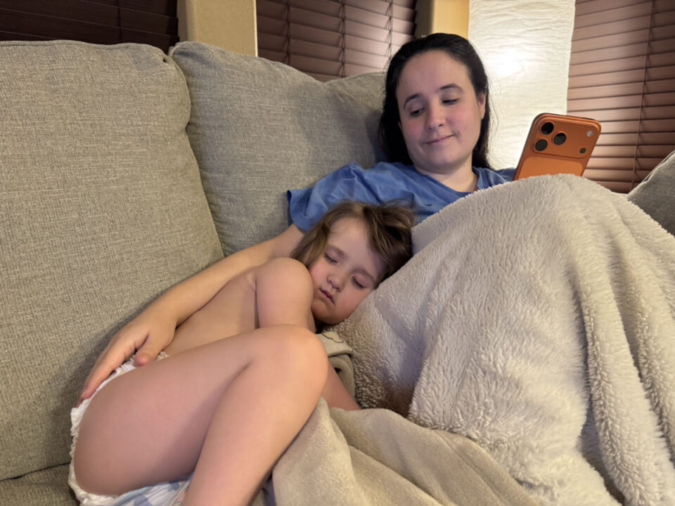 Olivia sleeping next to mommy on the couch