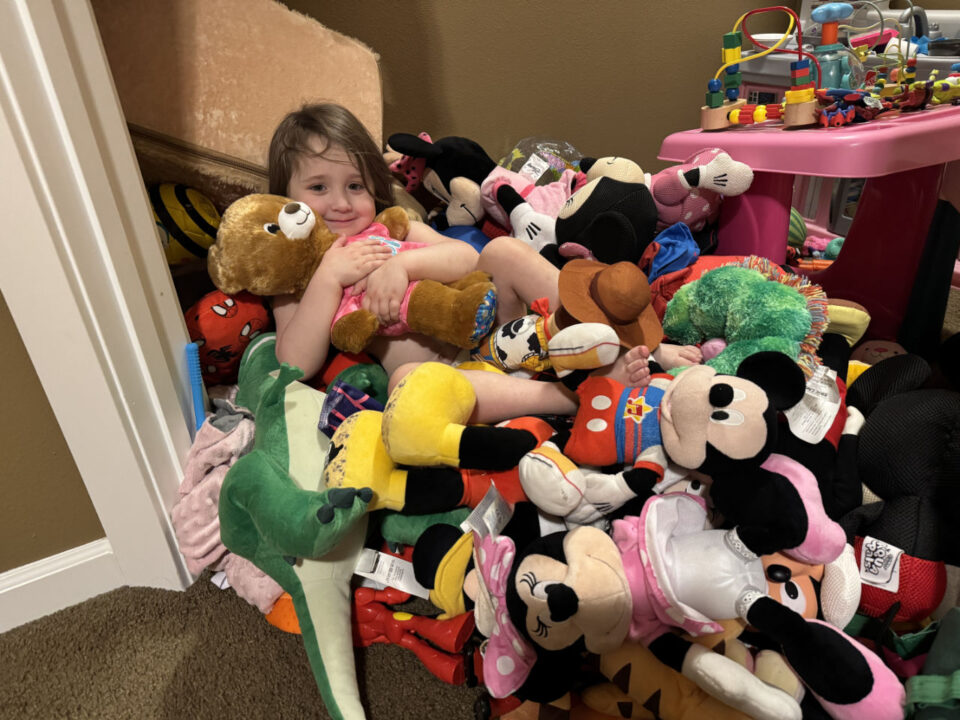 Olivia buried in plushies