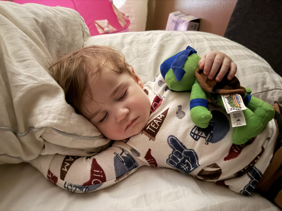 Jack sleeping with a ninja turtle plushie